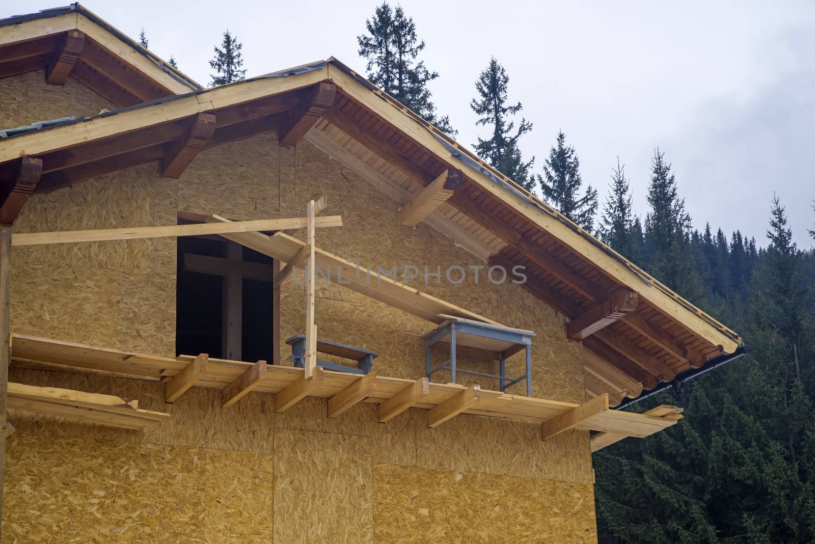 Wooden chalet construction in the forest, exterior works