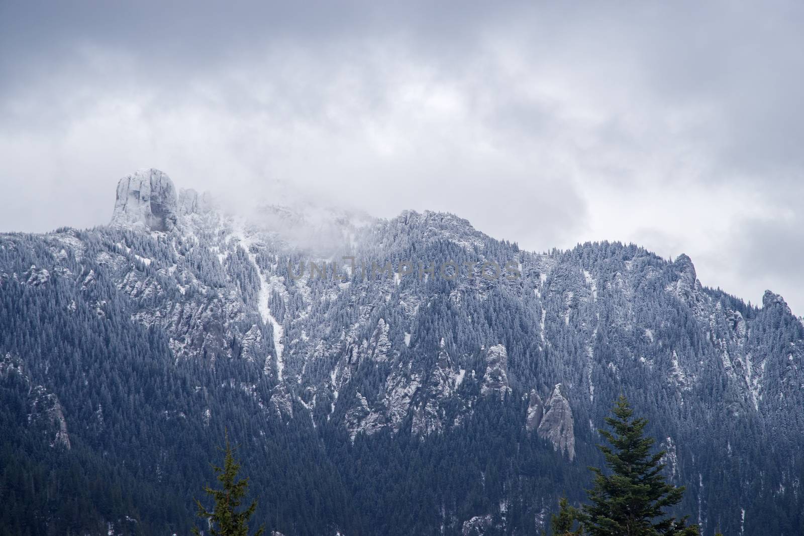 New snow cover on mountain summit, white rocky mountain in Romanian Carpathians.