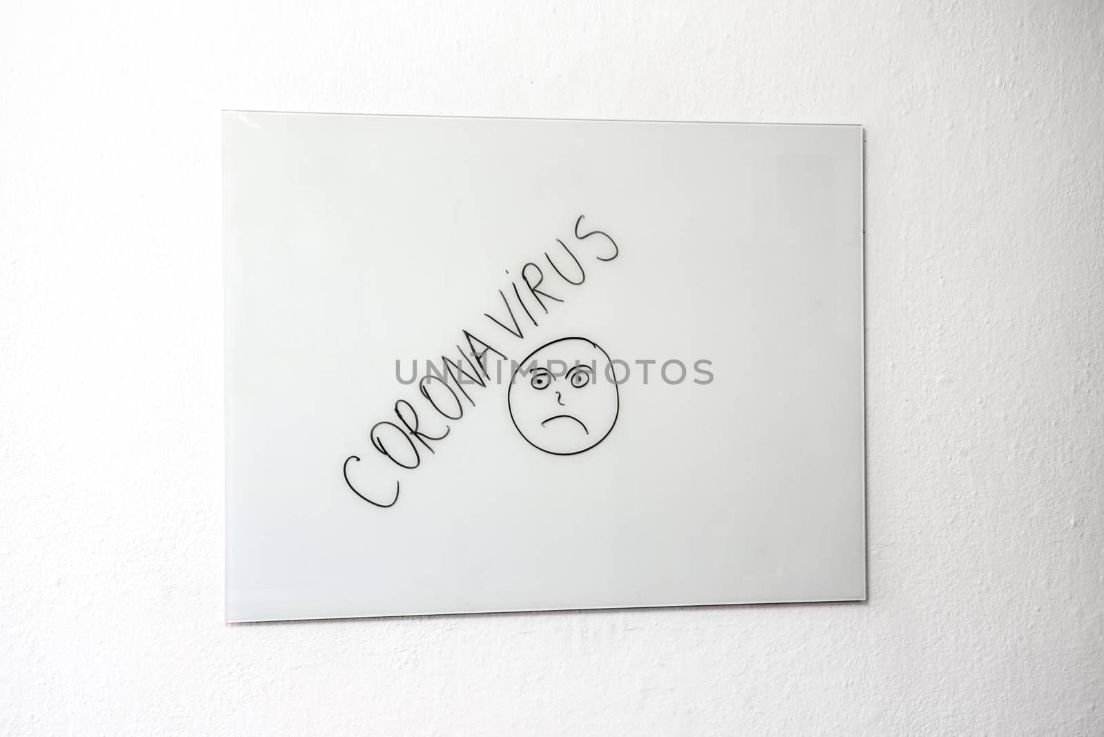 Sad face and Coronavirus on white board by savcoco