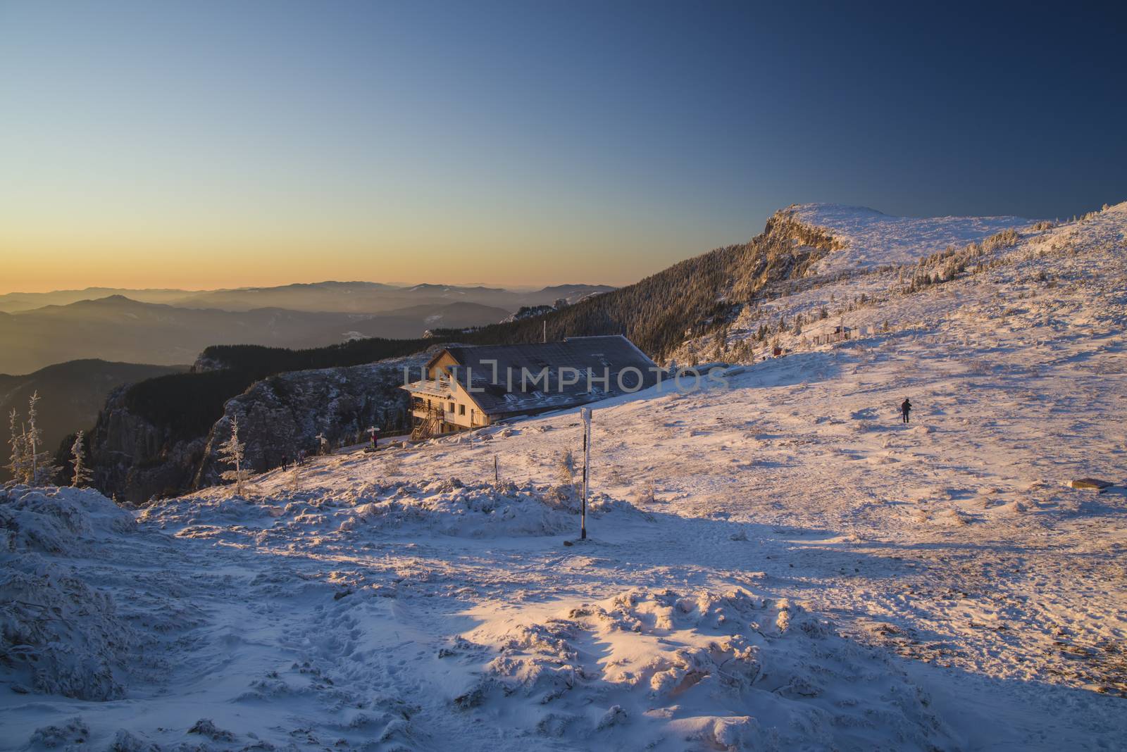 Mountain chalet landscape at sunrise in Romanian Carpathians, frozen scene