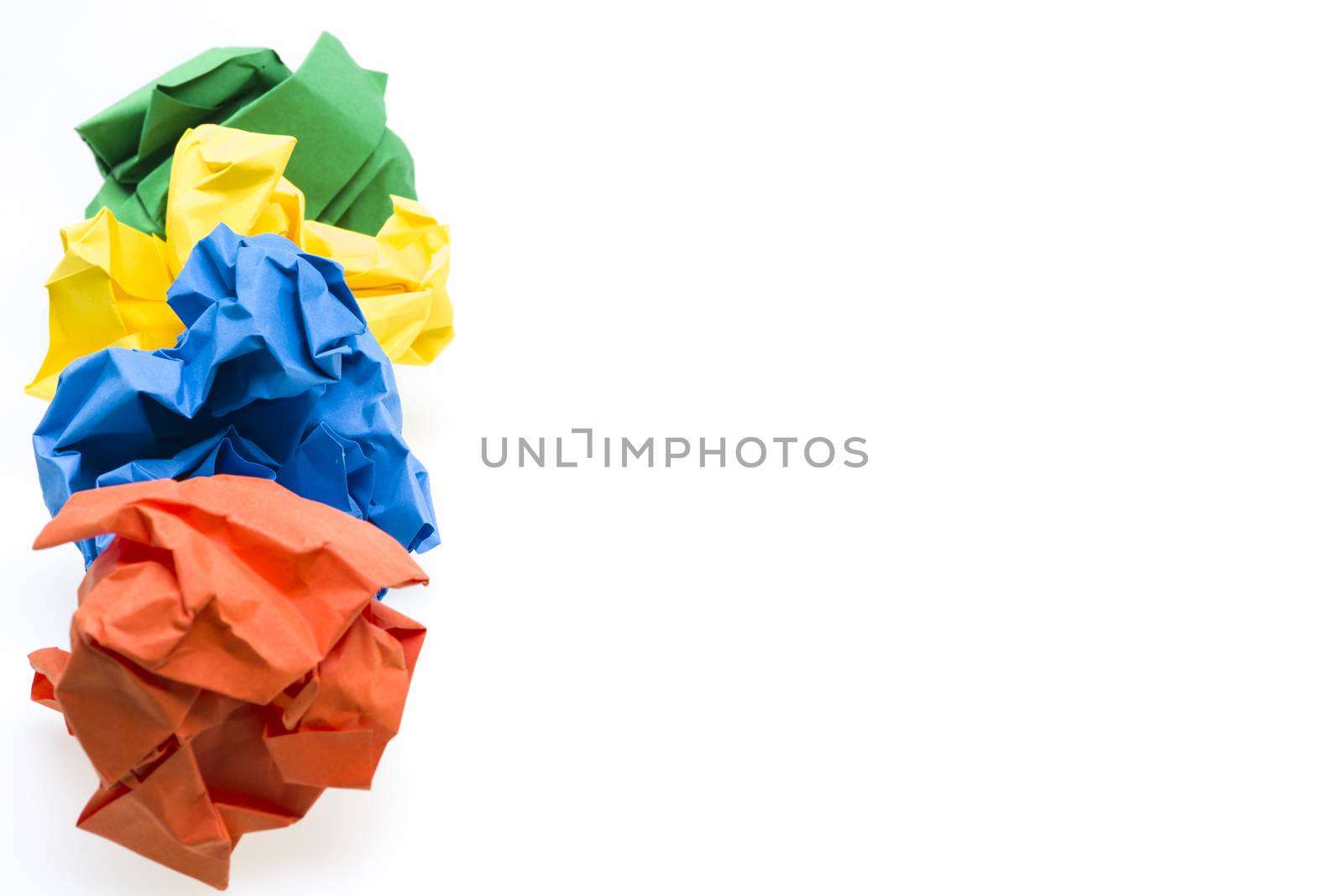 Colored crumpled paper ball in a row, focus on the blue one