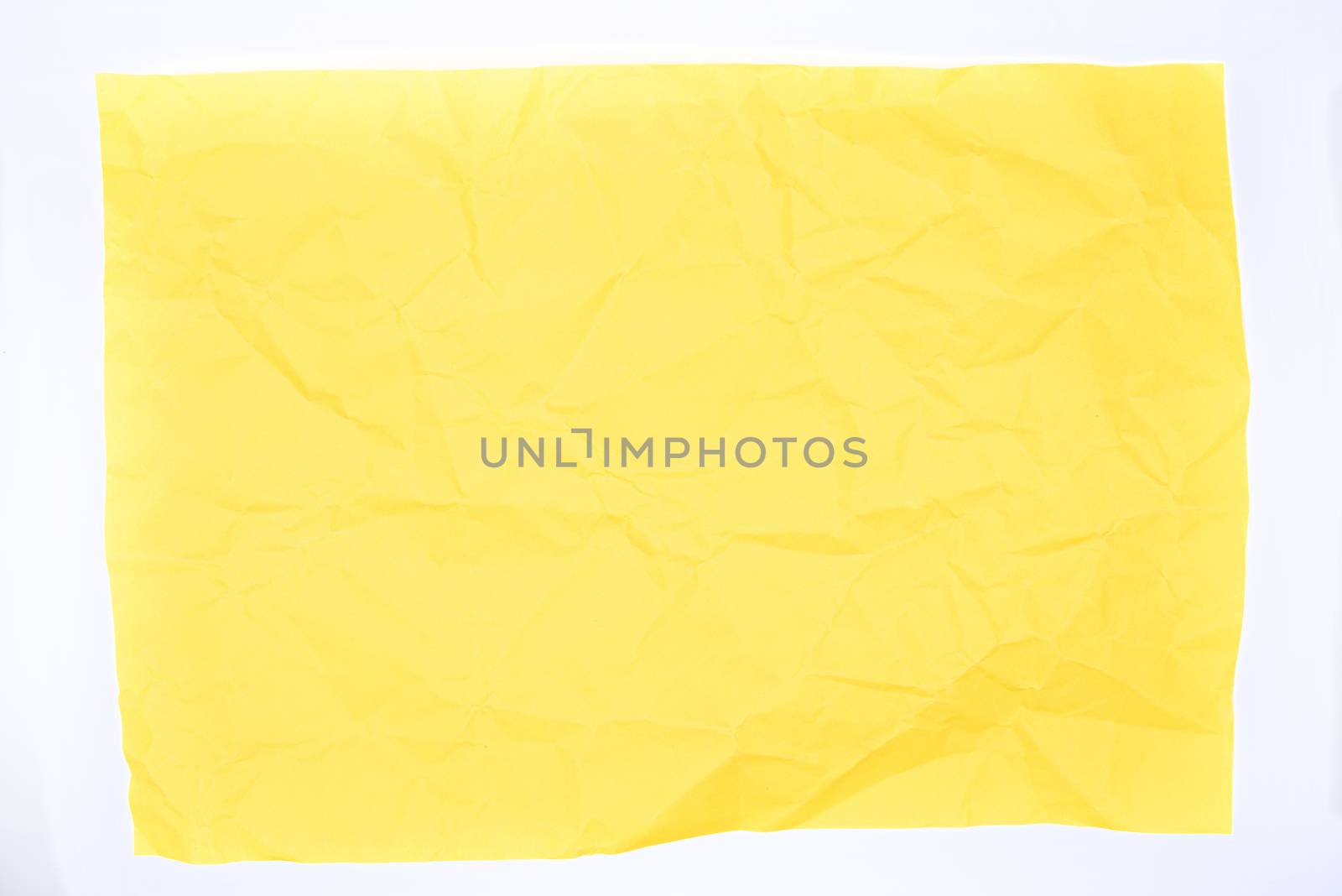 Yellow crumpled paper over a white background