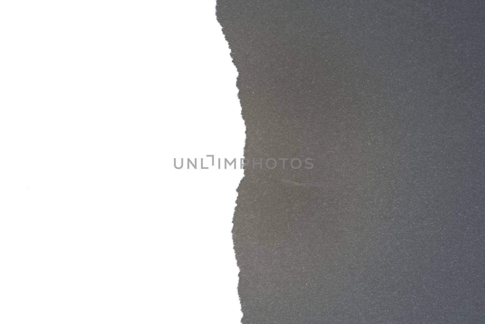 Half ripped white paper with black background