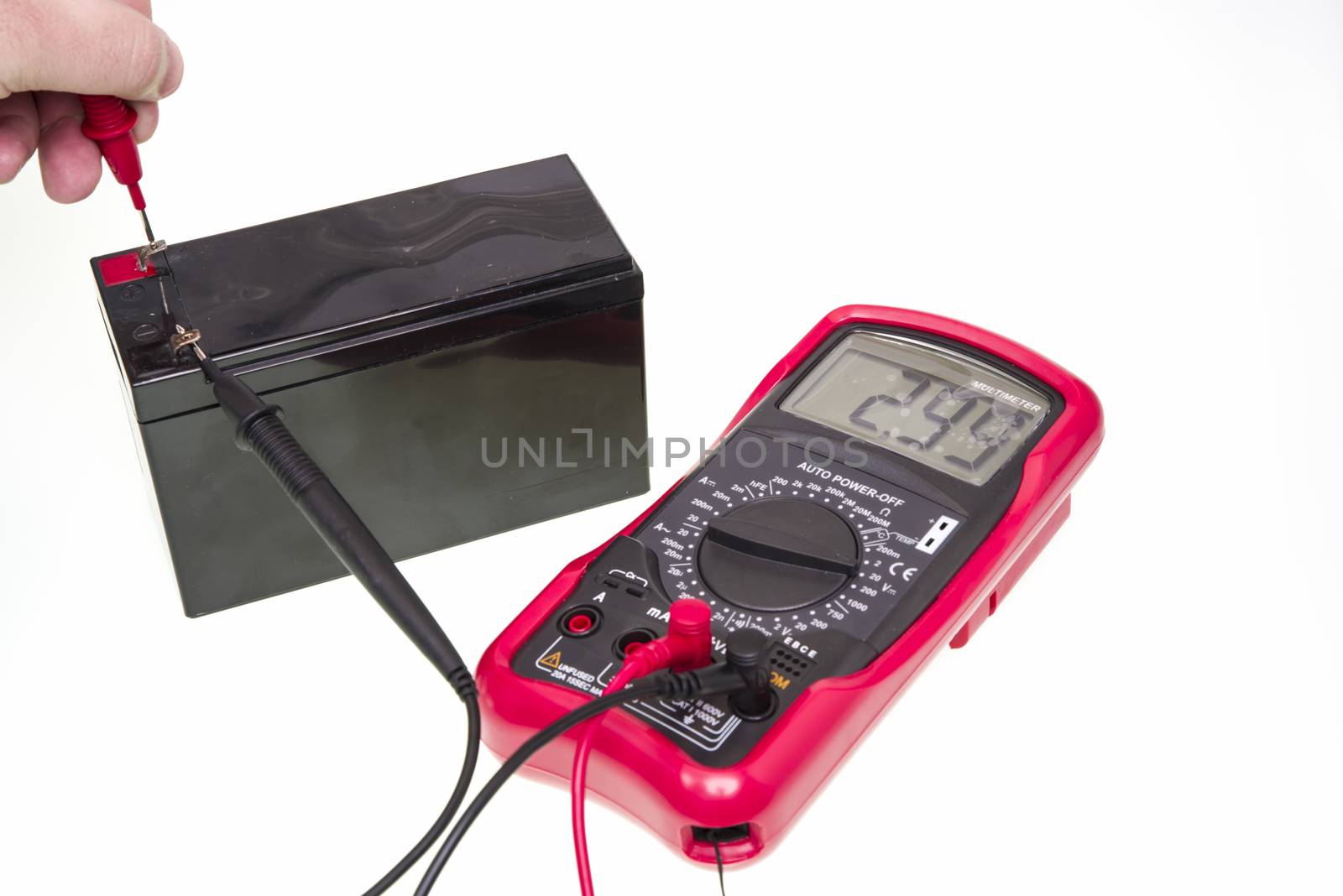Man measuring voltage of battery with digital multimeter instrument, over a white background