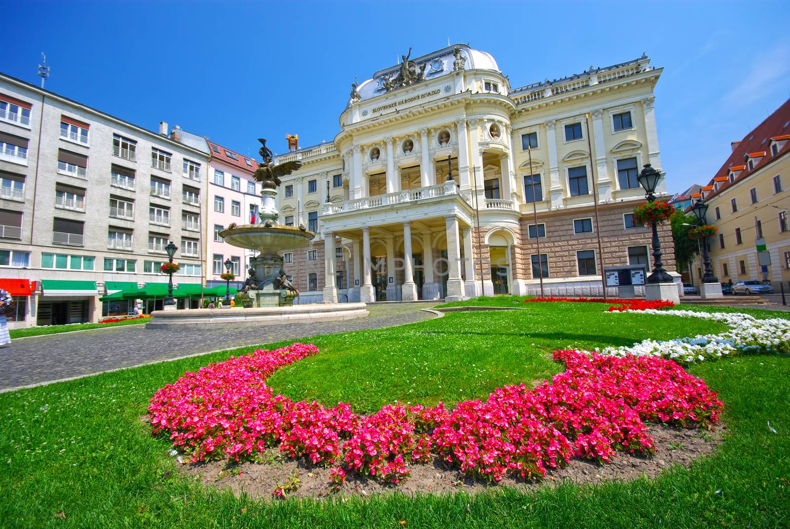 Summer landscape in Bratislava, Natioanl Theatre facade and beautiful flower garden