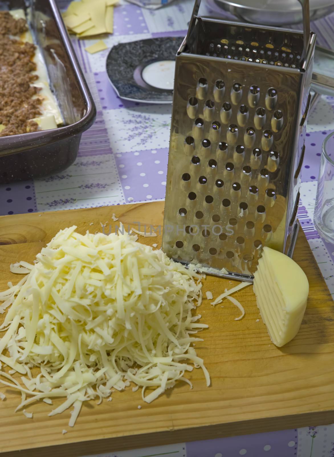 Grated hard cheese in the kitchen by savcoco