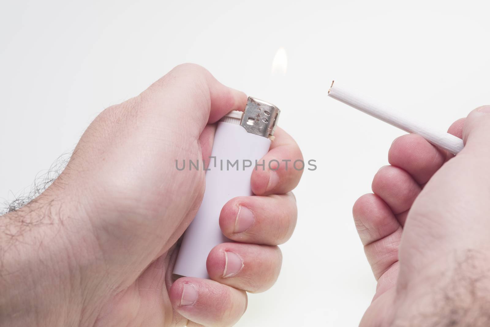 Man lights a cigarette isolated on white