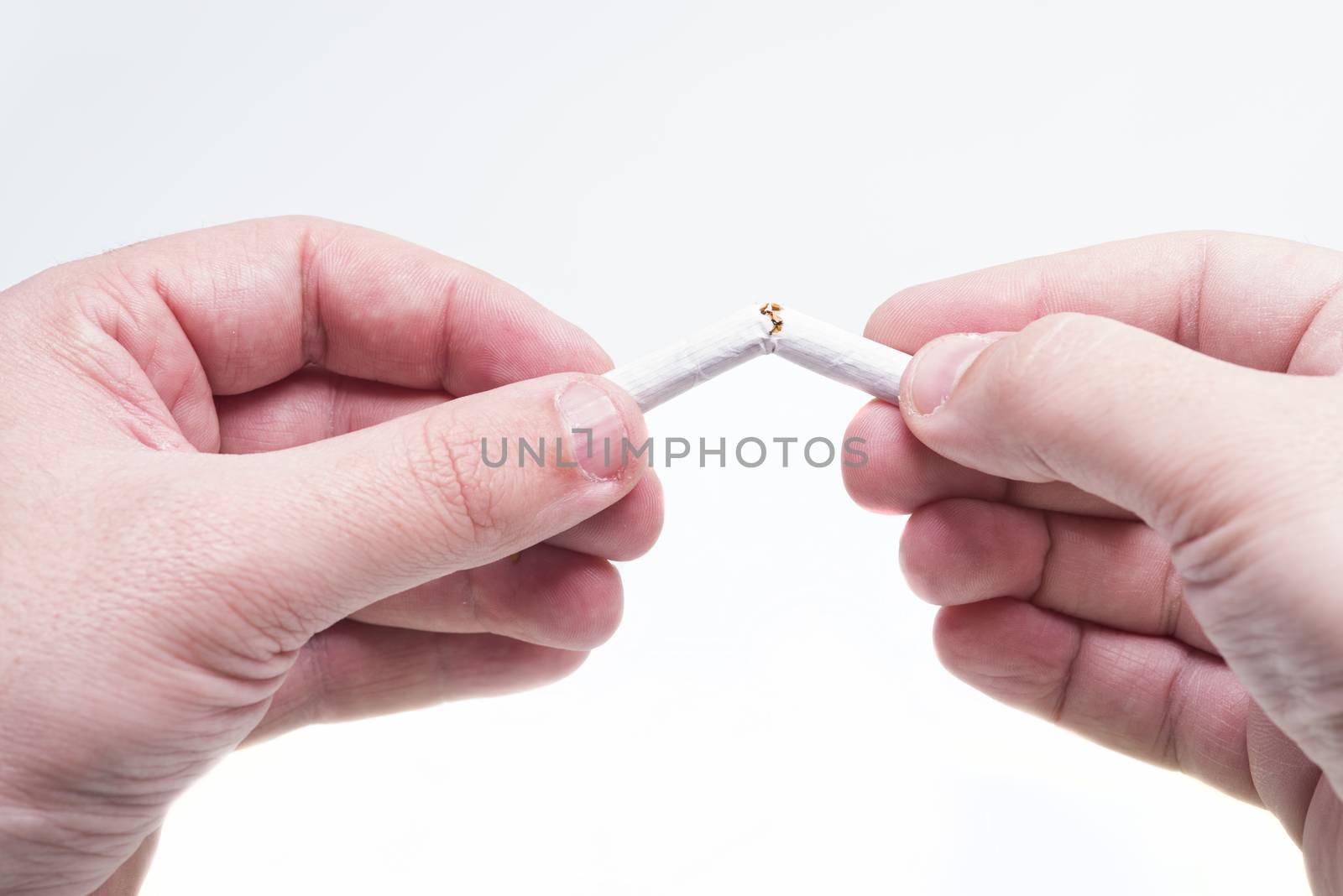 Broken cigarette in hands by savcoco