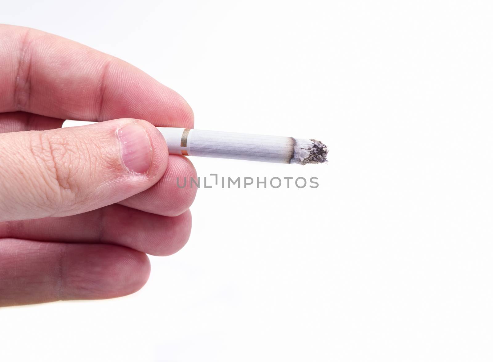 Man hand holding a burning cigarette over white
