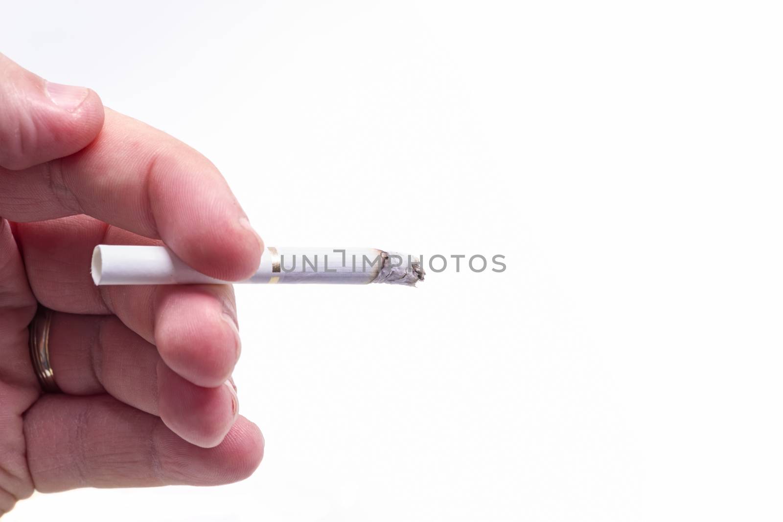 Man hand and burning cigarette isolated over white