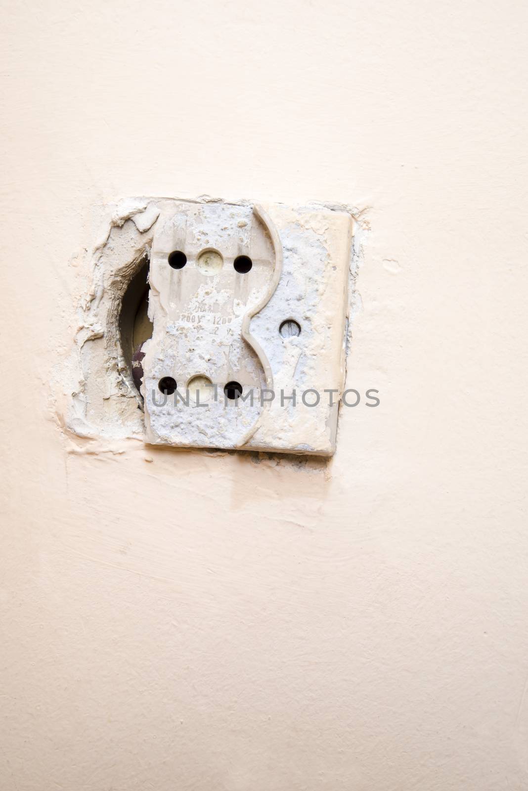 Old and broken electrical socket on the wall