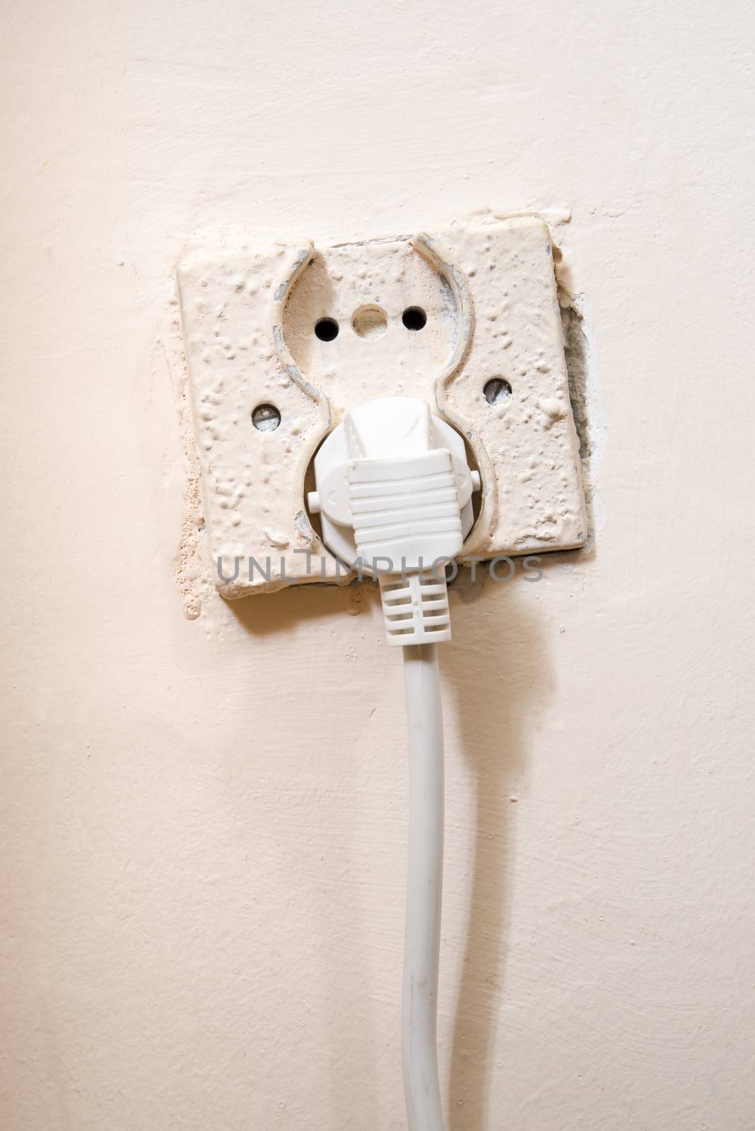 Old power socket with electric cable plug
