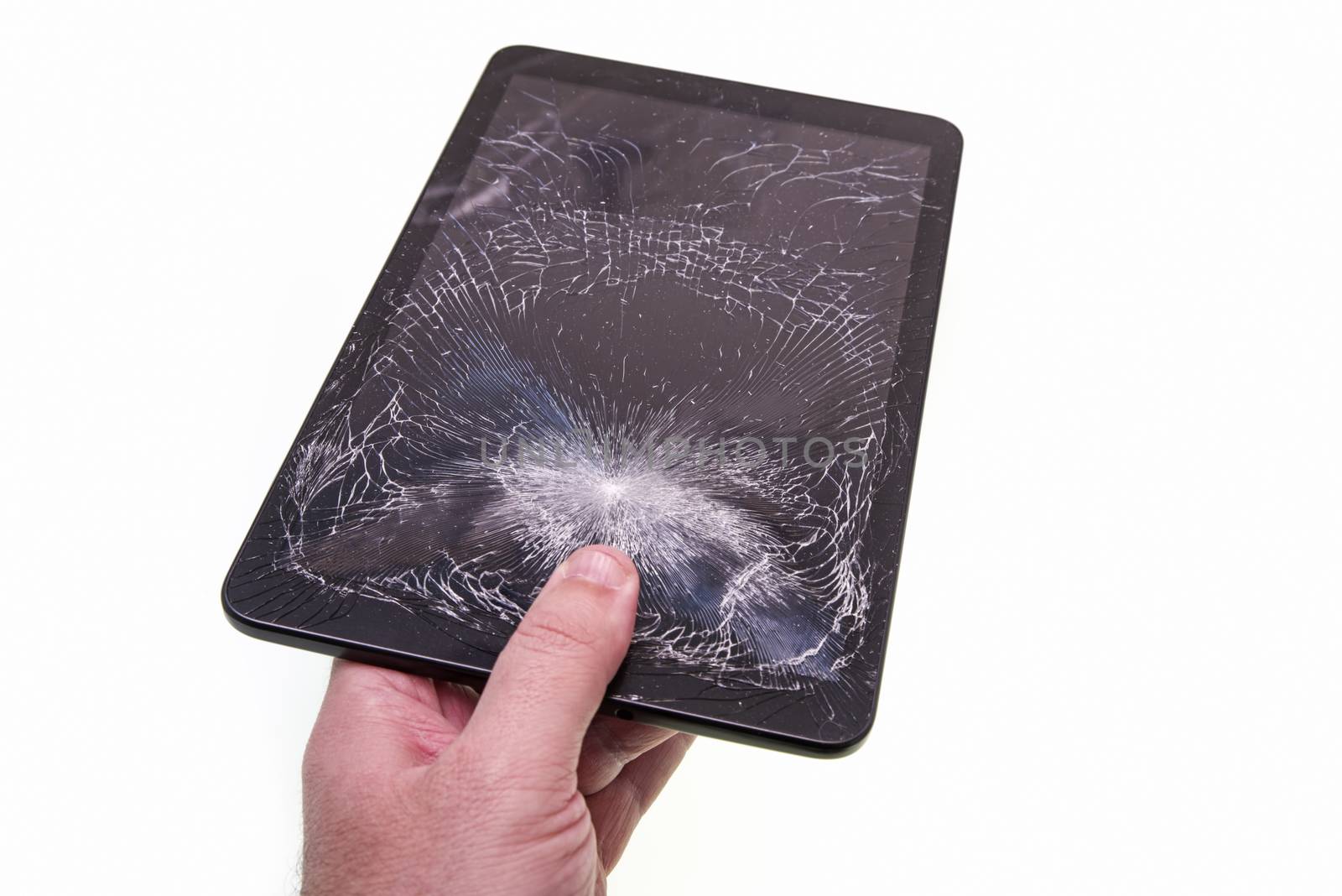 Hand holding a cracked tablet over white bacground