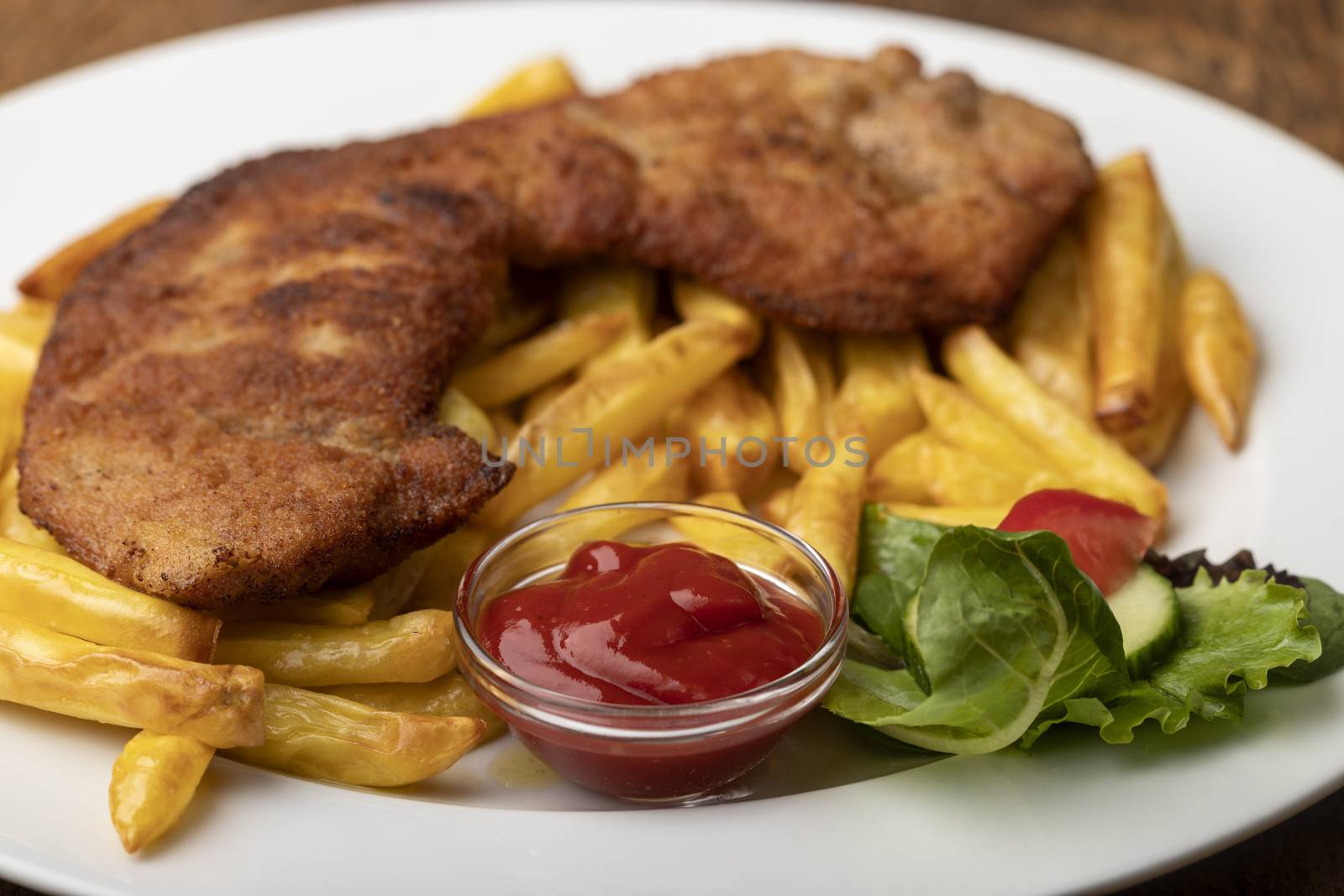 wiener schnitzel with french fries on a plate