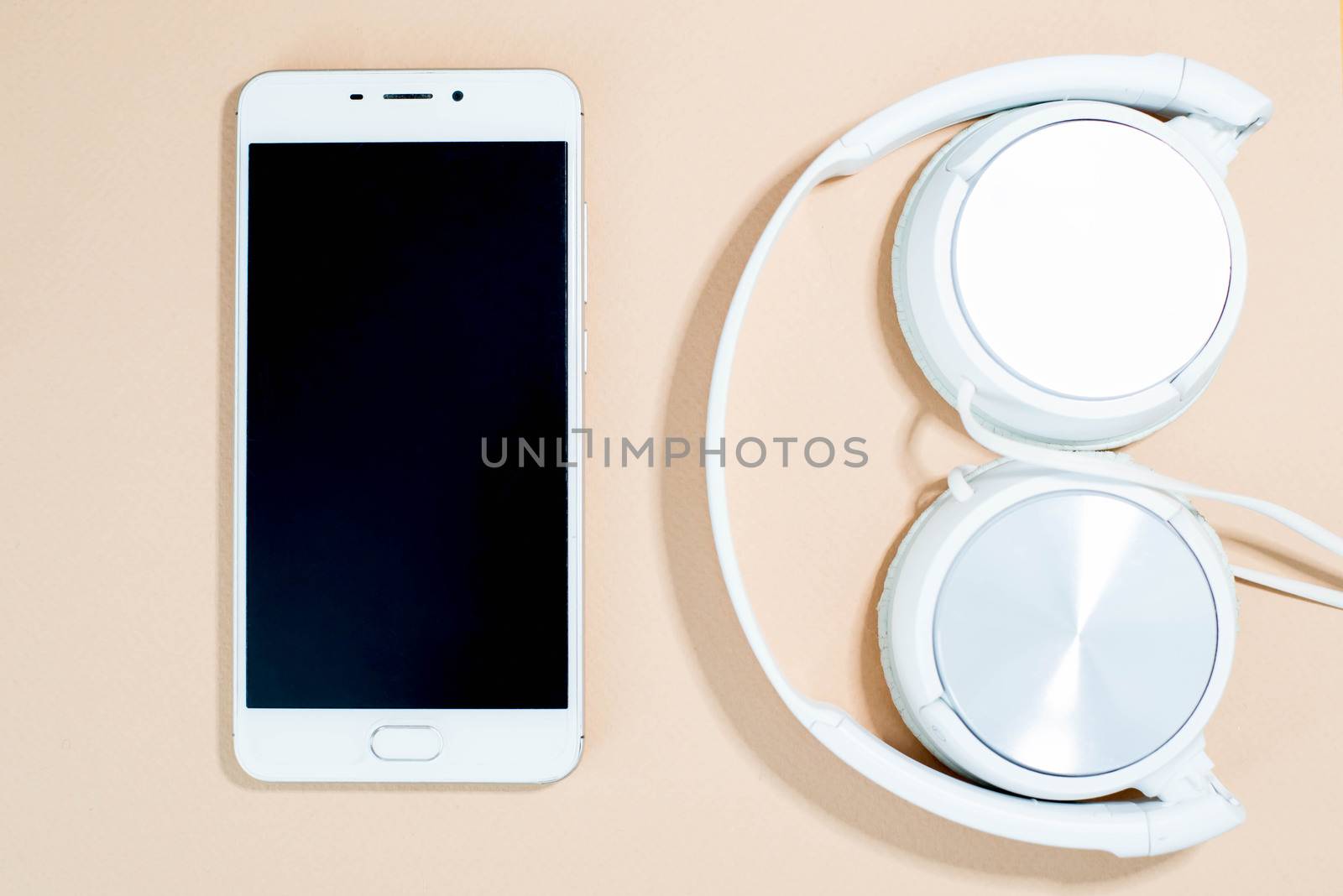 Smartphone and headphones on a pink background by SemFid