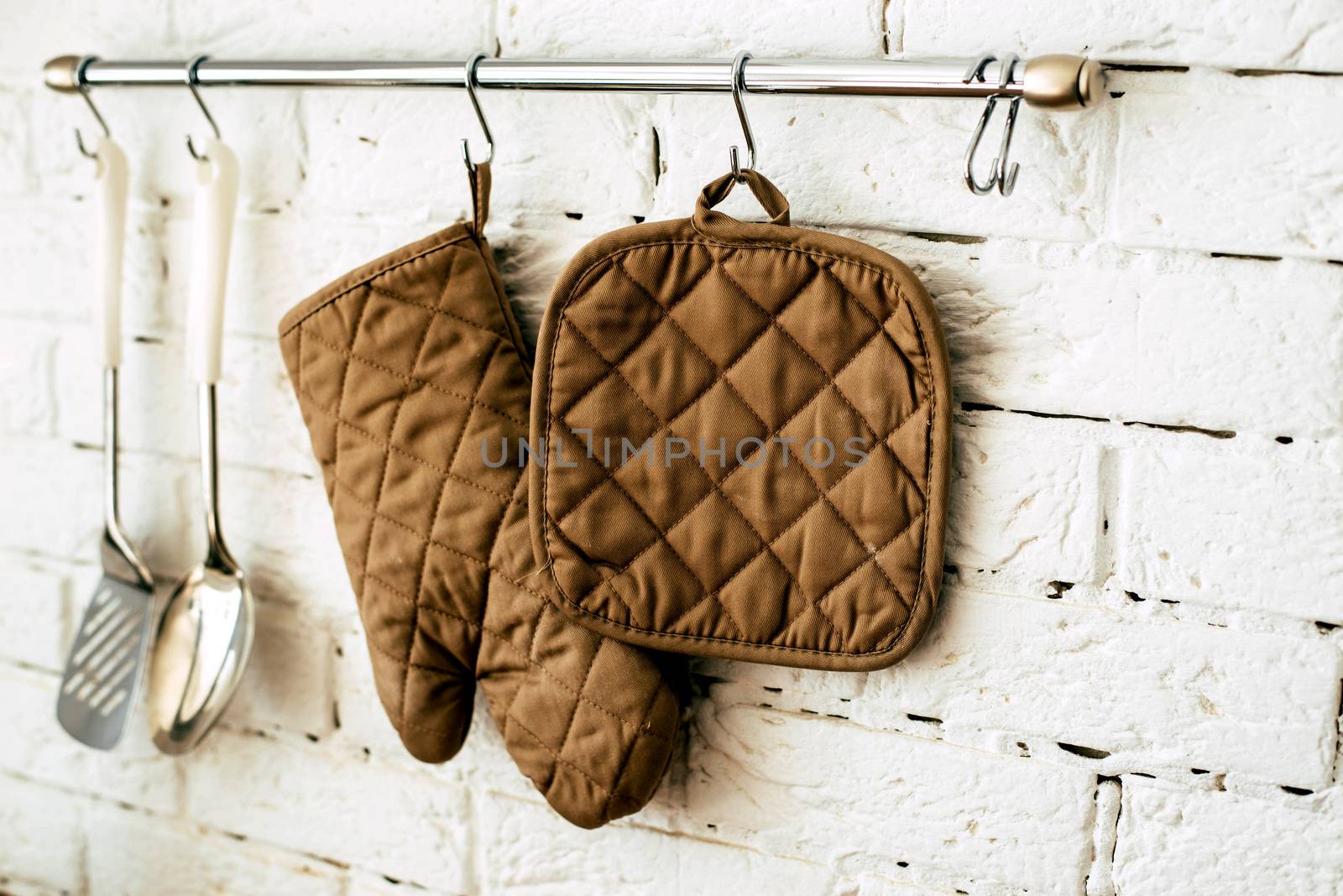 Kitchen utensils on a background of white brick wall by SemFid