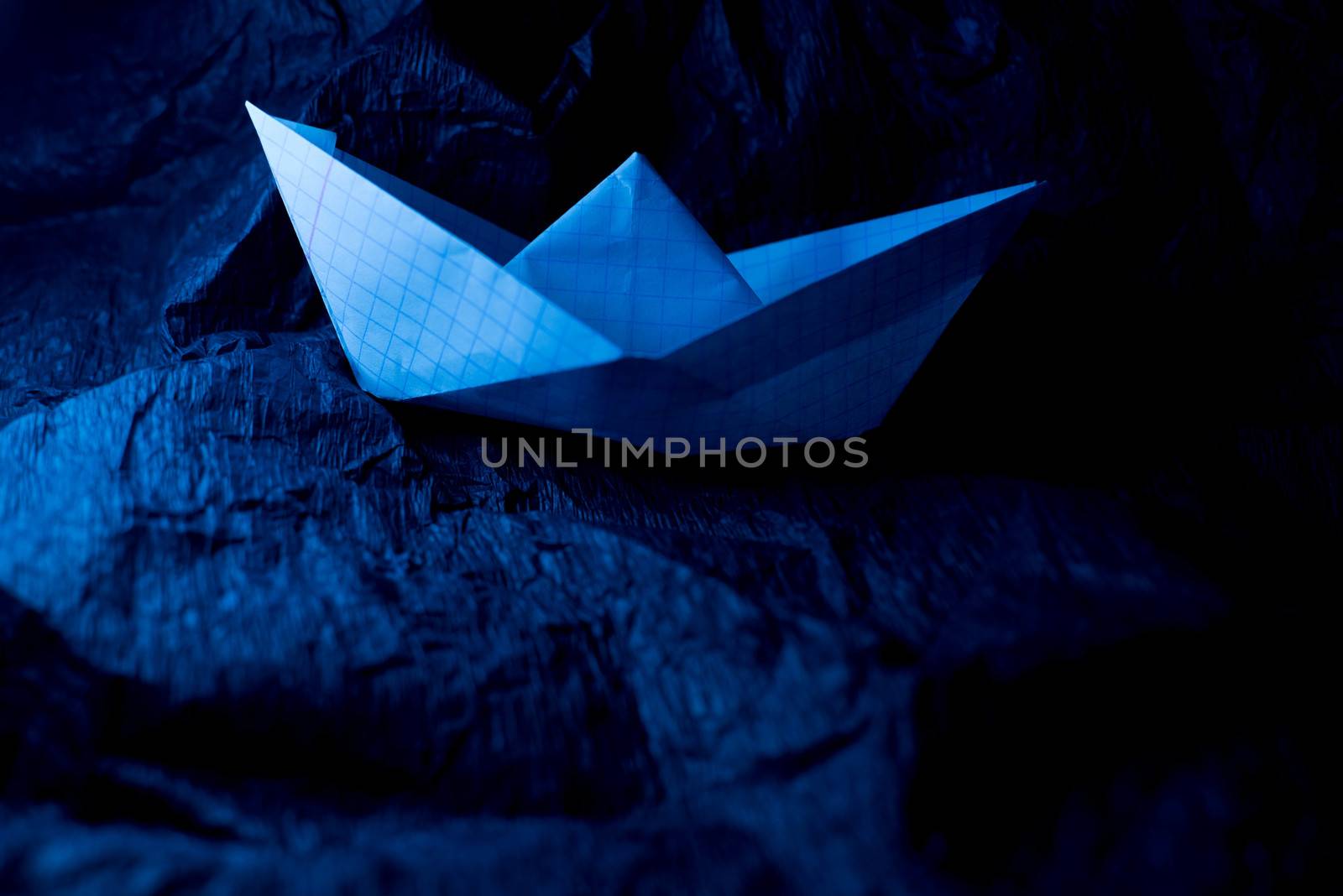Paper boat on colored backgrounds