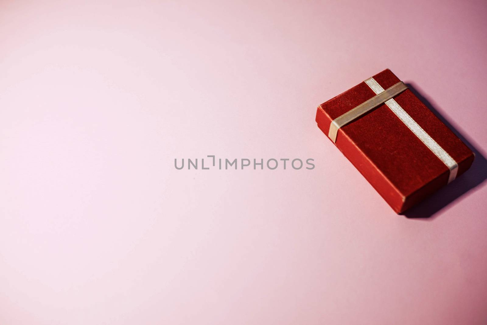 Red gift box on a pink background by SemFid