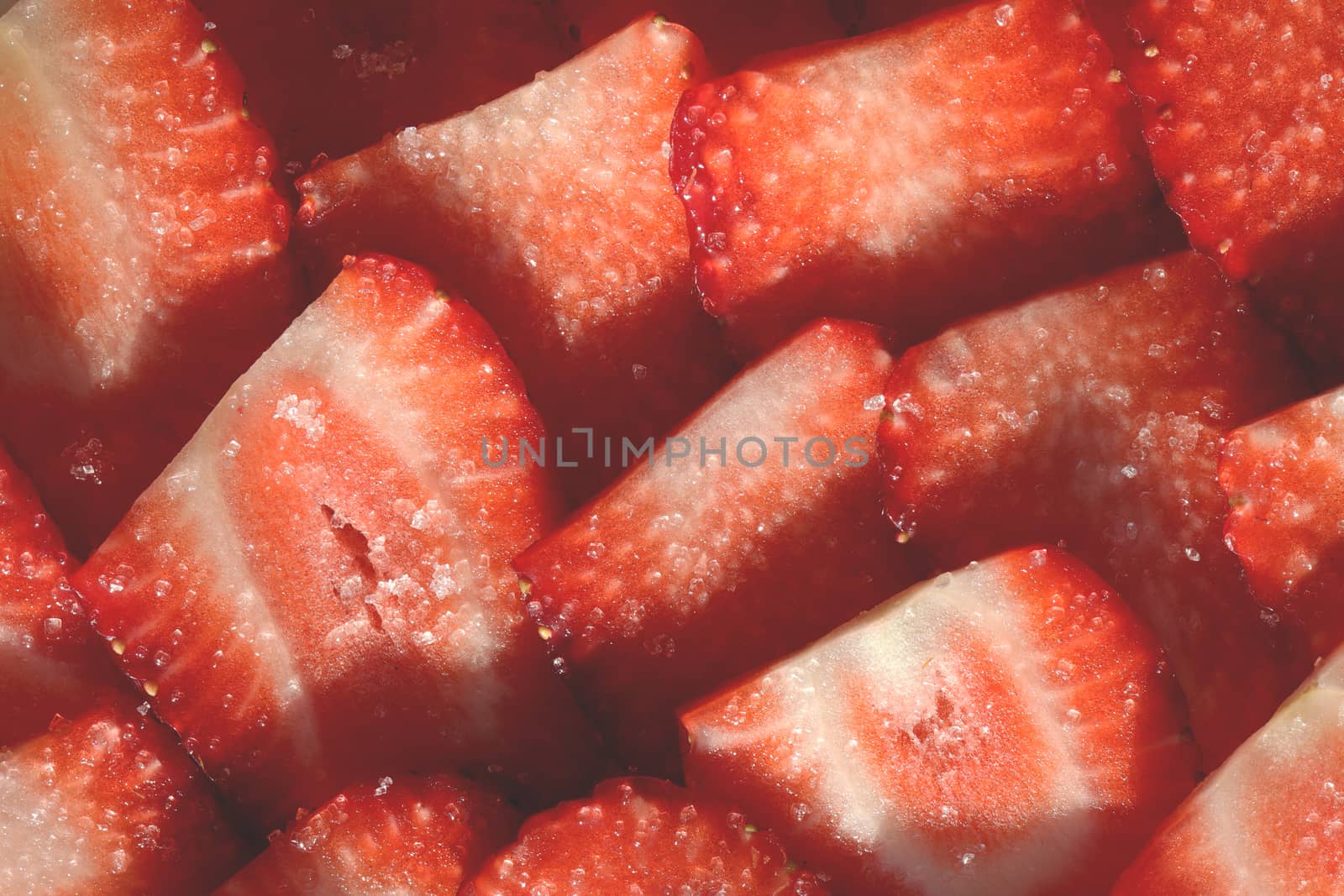 Vitamin berry backdrop. Strawberry slices in sugar filling background. Strawberry with sugar texture.