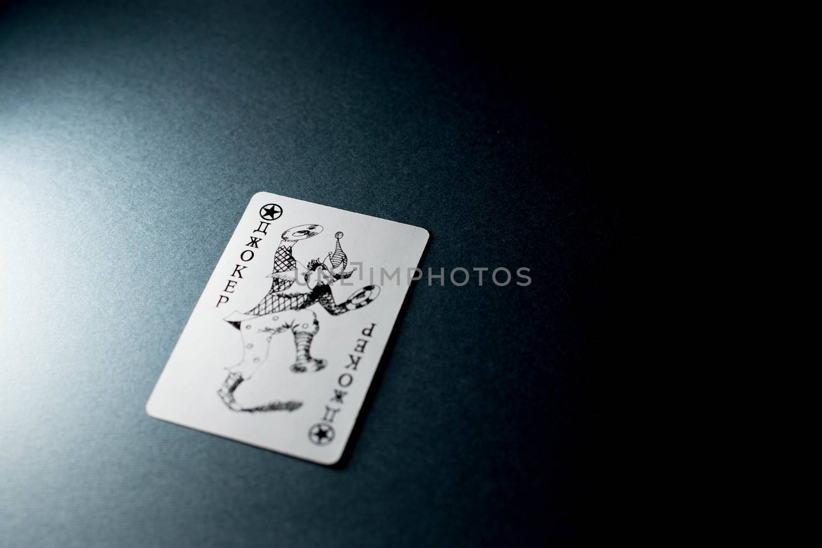 Joker card on a black background by SemFid
