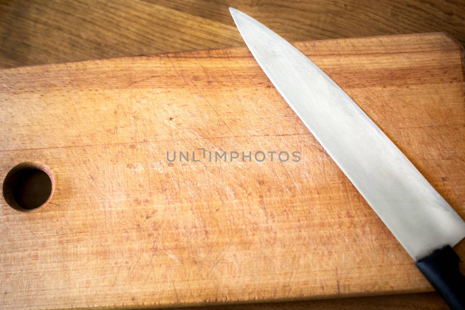 Kitchen knife on a wooden board