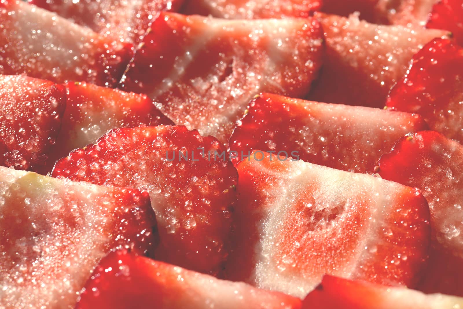 Strawberry slices in sugar filling background. Strawberry with sugar texture. Vitamin berry backdrop.