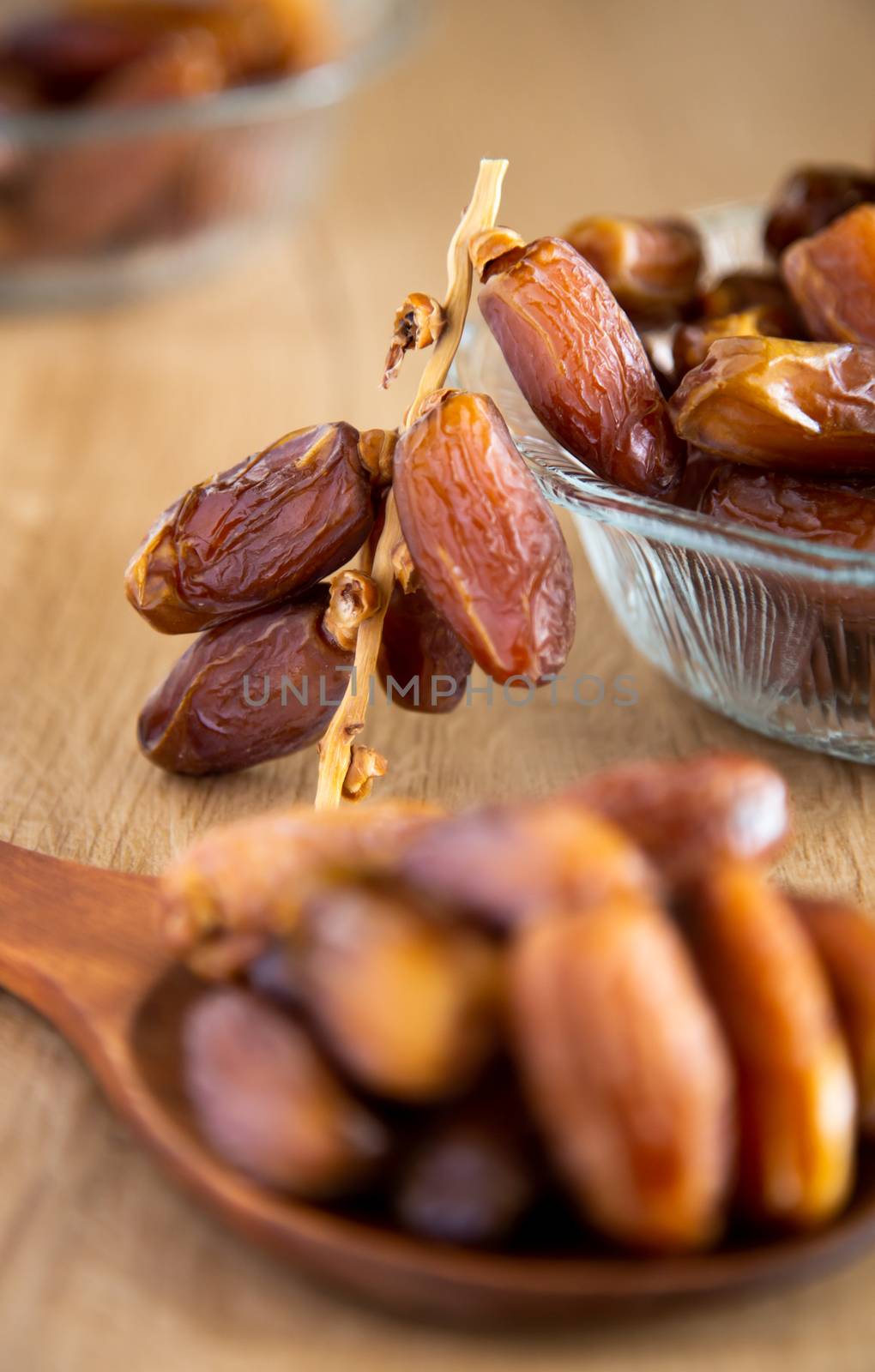 Kurma or dates on wooden background by tehcheesiong