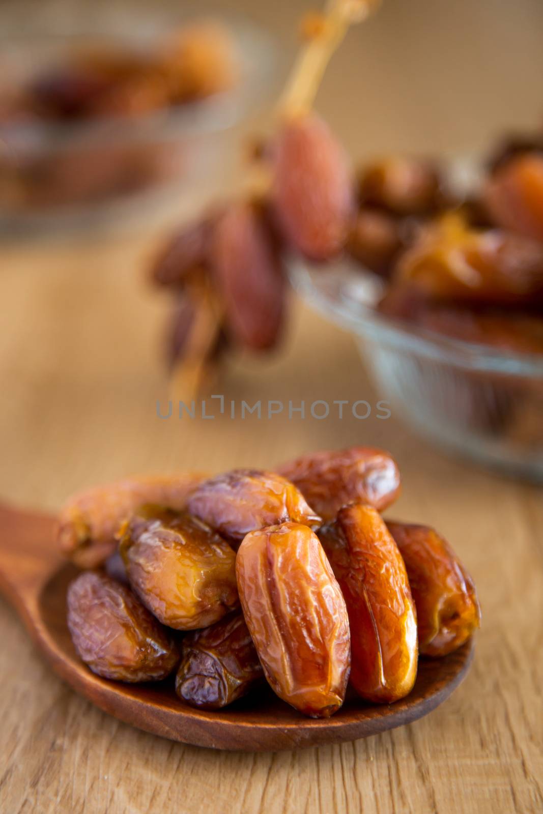 Kurma or dates on wooden background by tehcheesiong