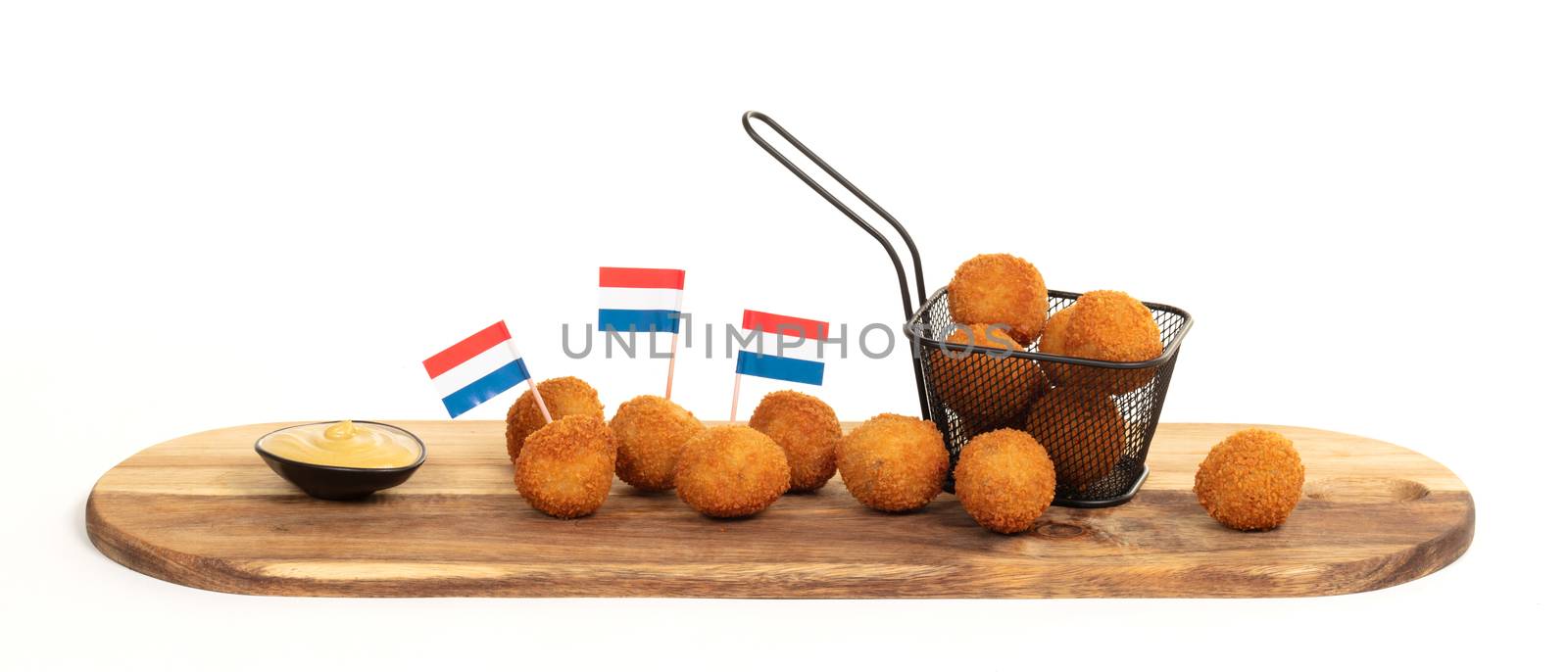 Dutch traditional snack bitterbal on a serving board by michaklootwijk
