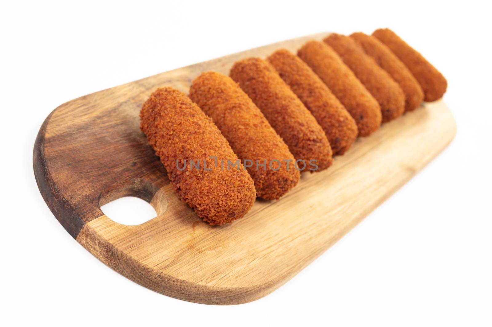 Brown crusty dutch kroketten on a serving tray, isolated on a white background