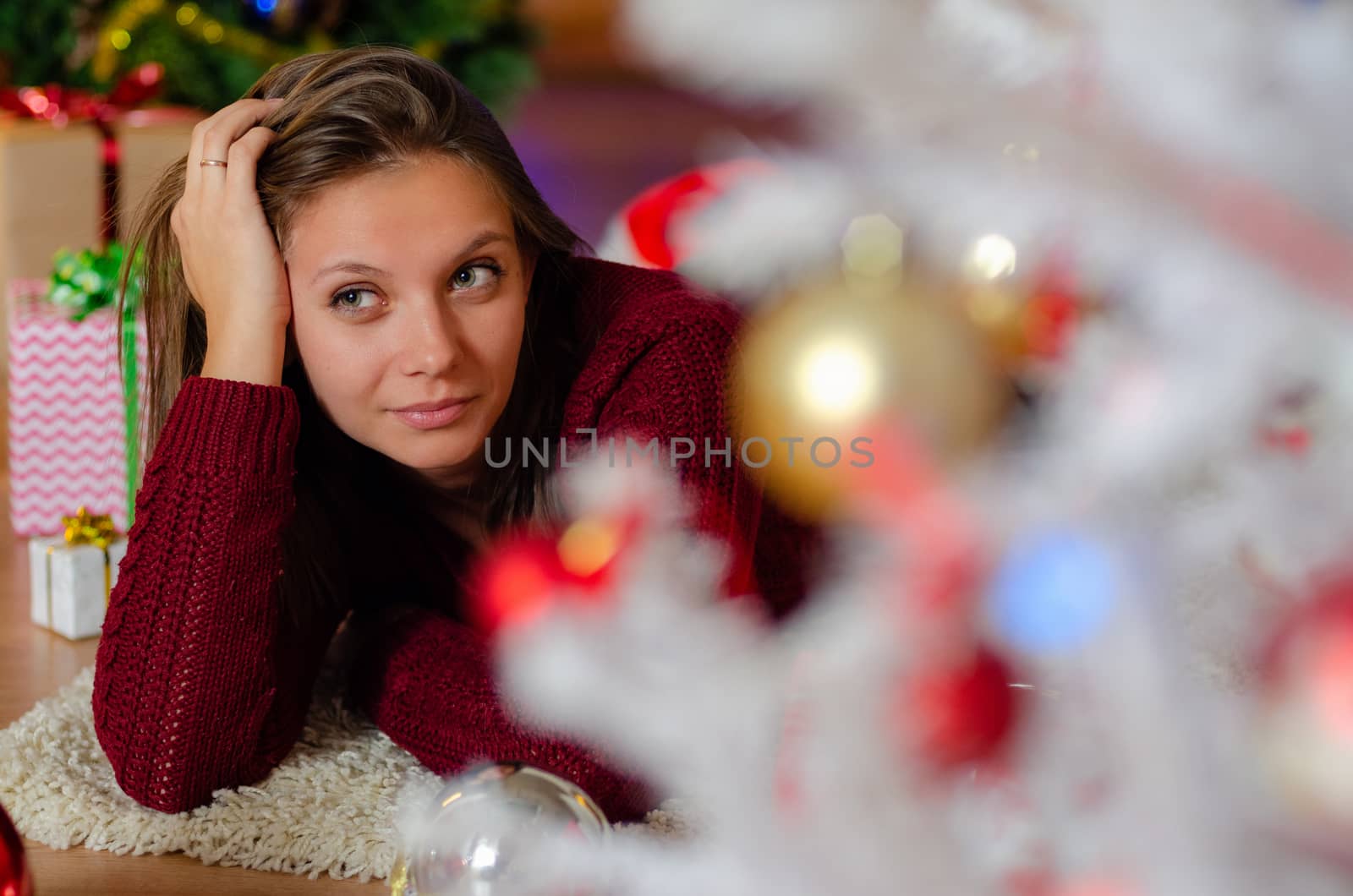 portrait of a beautiful brooding girl behind a Christmas tree by Madhourse