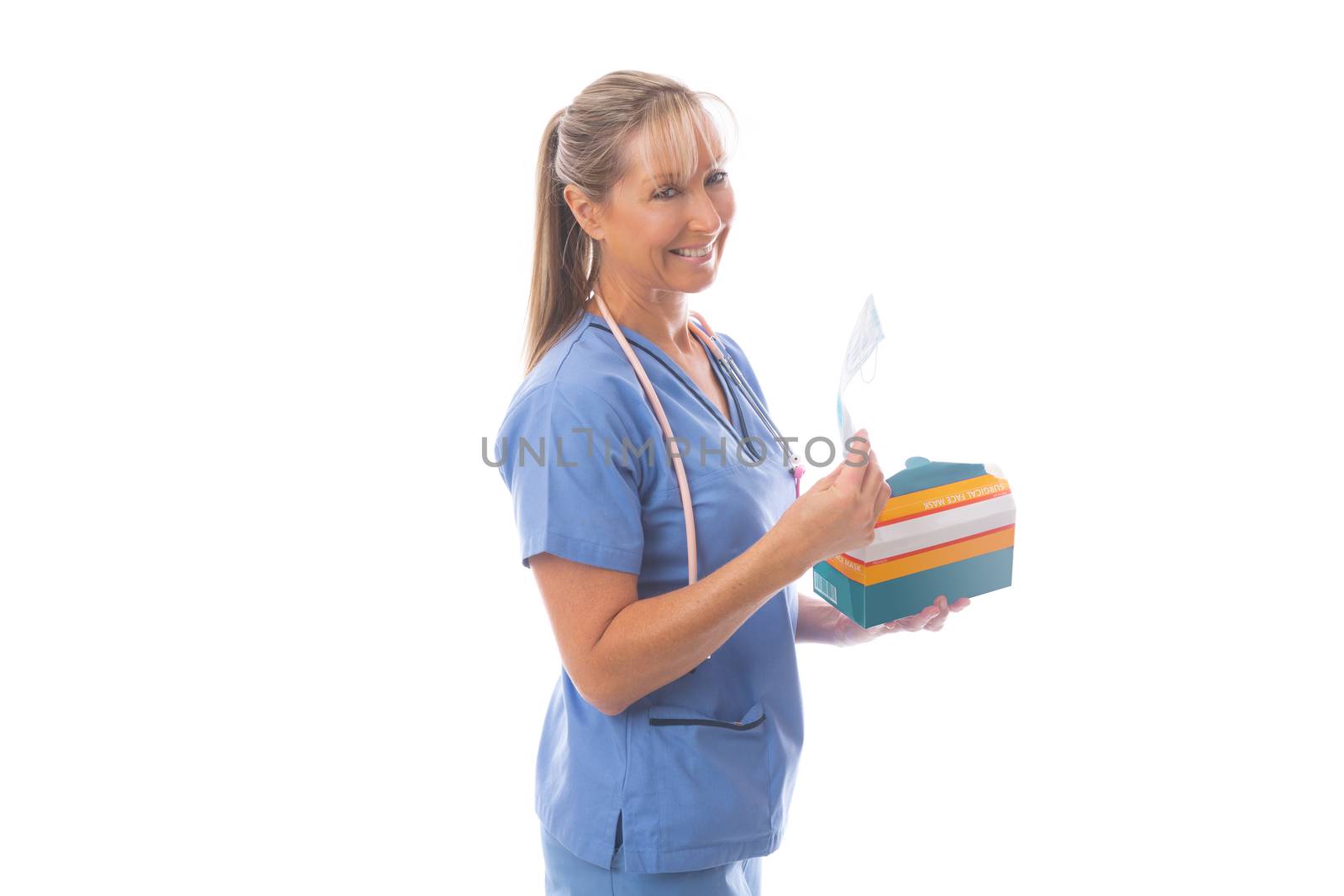 Doctor, nurse or other healthcare worker holds a box of surgical face masks.  During coronavirus pandemic, healthcare workers were in short supply of protective PPE like masks.