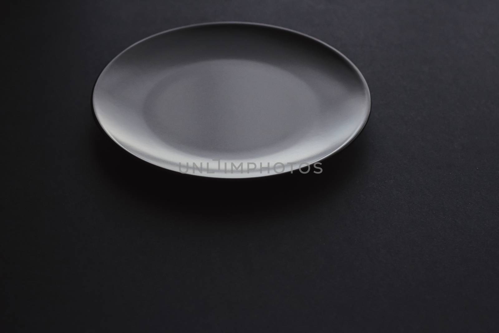 Empty plates on black background, premium dishware for holiday dinner, minimalistic design and diet concept