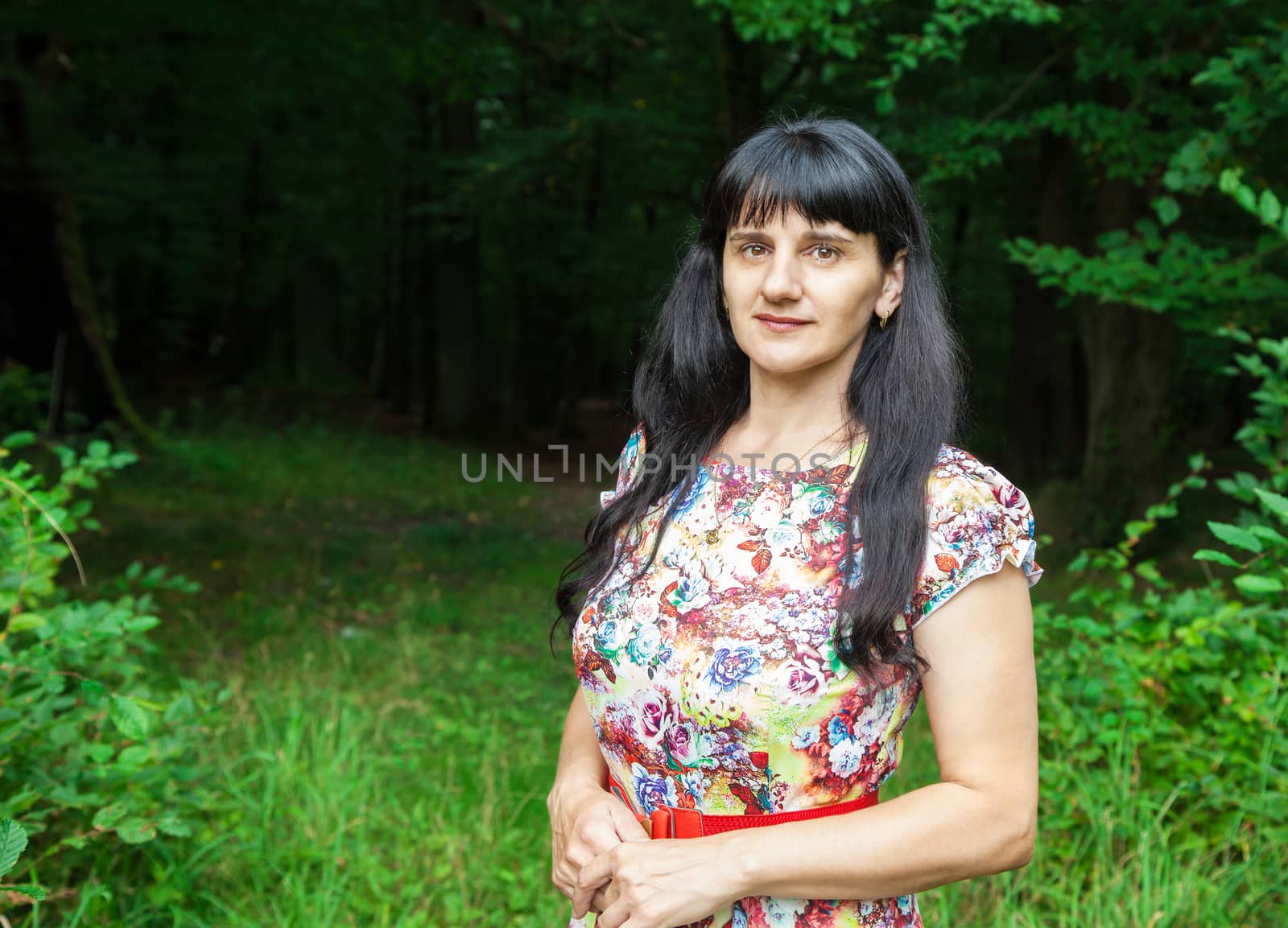 portrait of a beautiful young brunette in a forest