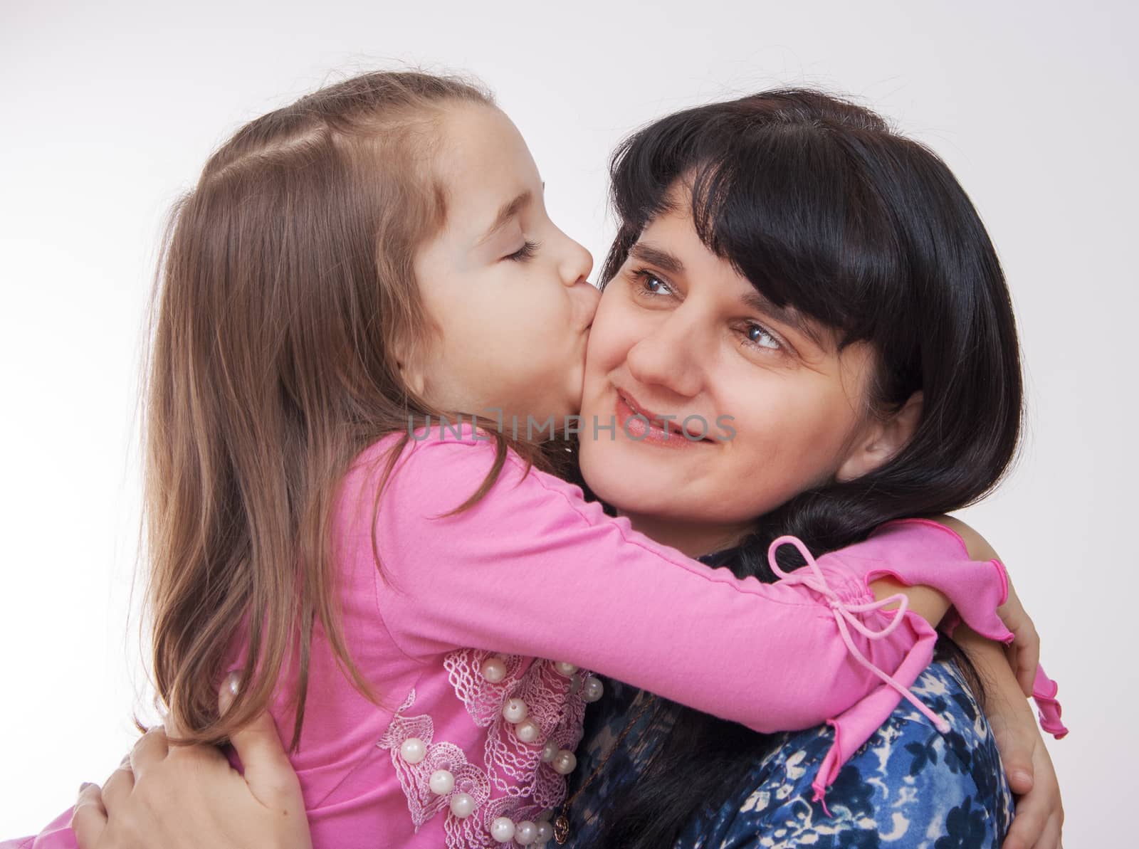 little girl kissing her mother