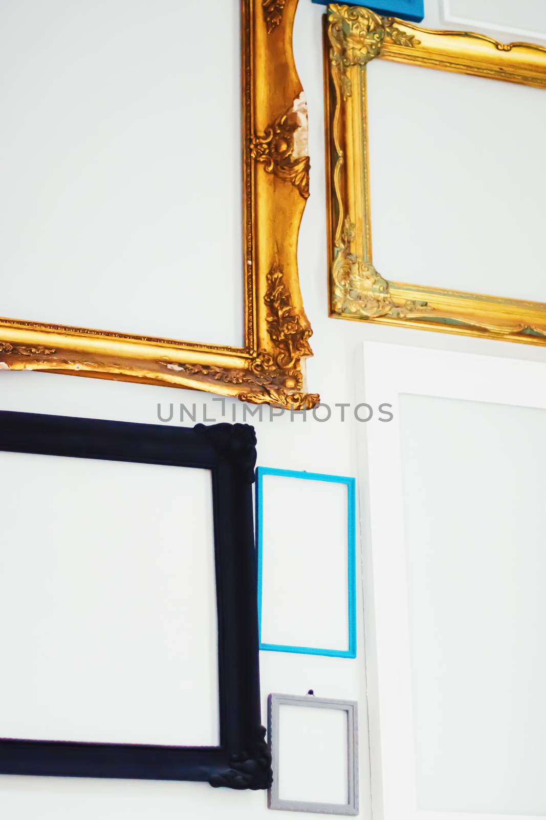 Empty art frames on gallery wall, decor and design details