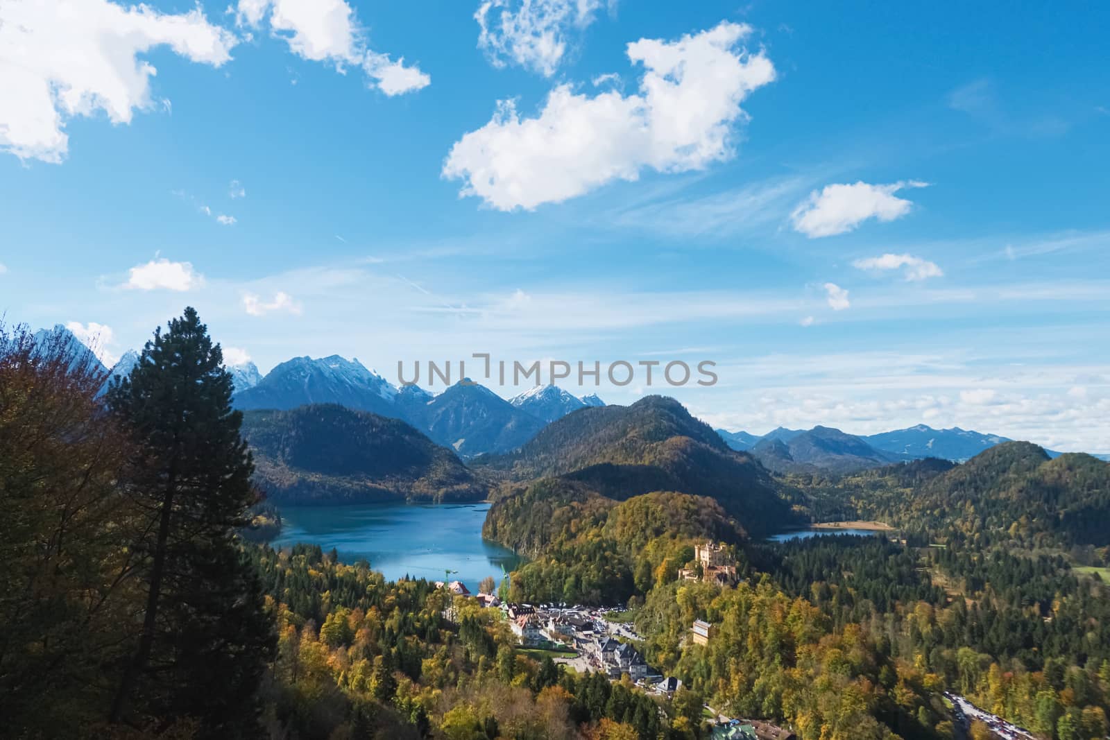 Beautiful nature of European Alps, landscape view of alpine mountains, lake and village on a sunny day, travel and destination scenery