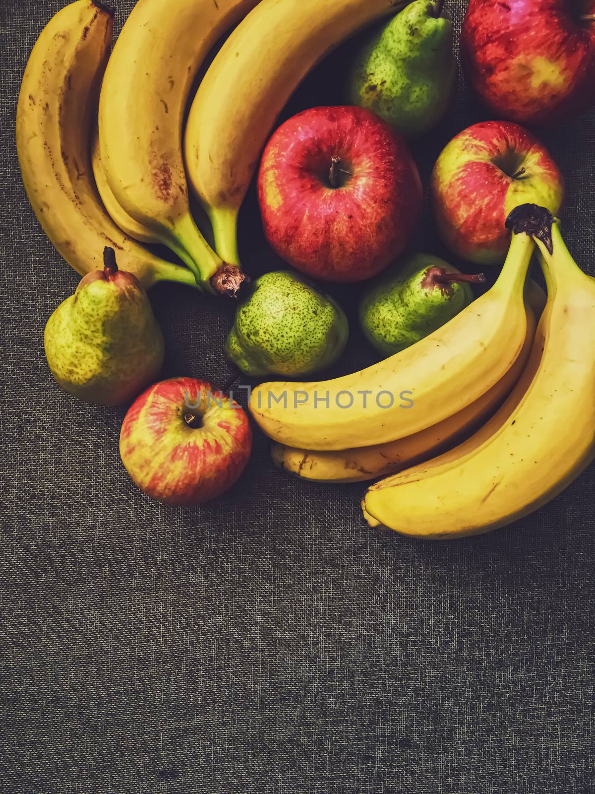 Organic apples, pears and bananas on rustic linen background, fruits farming and agriculture