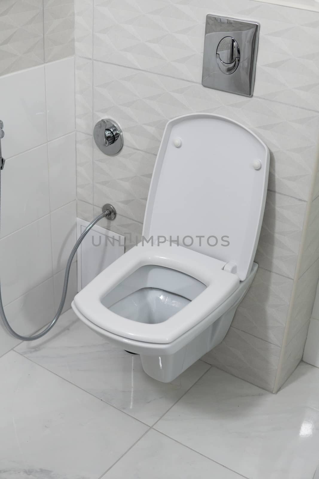 White toilet bowl in modern light bathroom interior