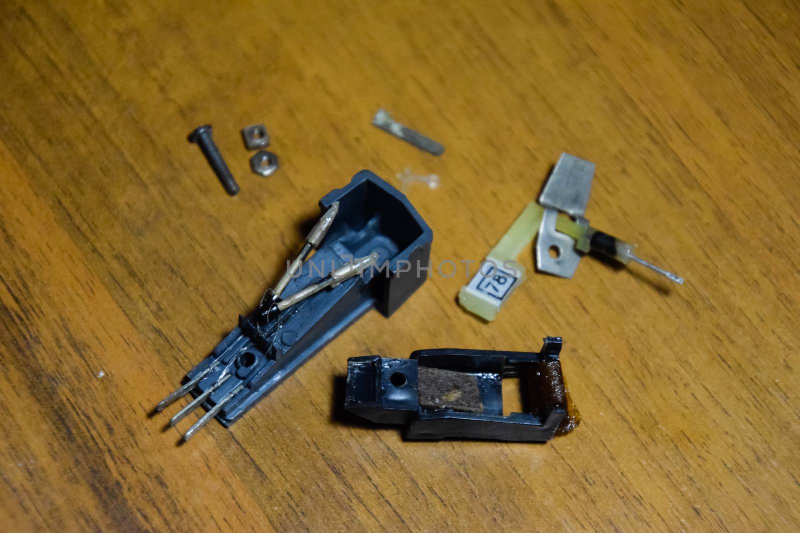 Disassembled vinyl player pickup with a rotary needle.