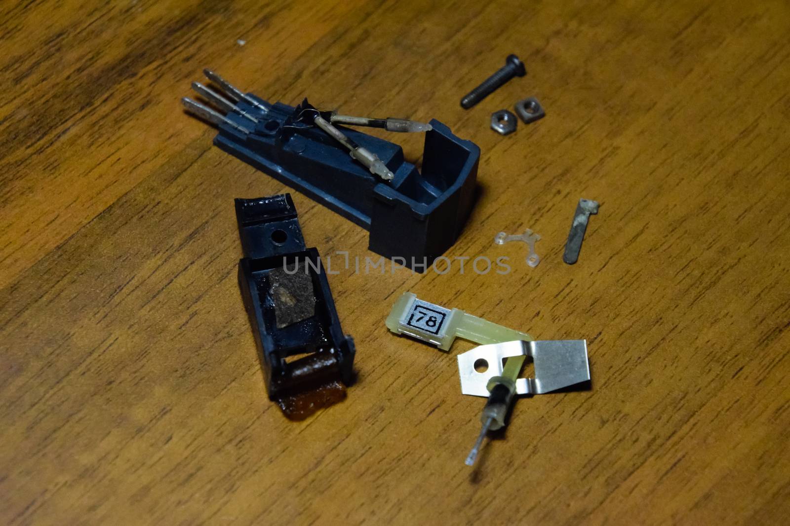 Disassembled vinyl player pickup with a rotary needle.