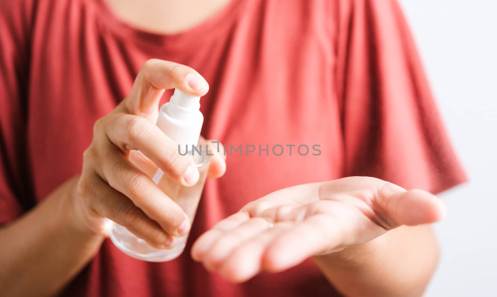 Closeup Hand Asian young woman applying spray pump dispenser sanitizer alcohol on hand wash cleaning, hygiene prevention COVID-19 or coronavirus protection concept, isolated on white background