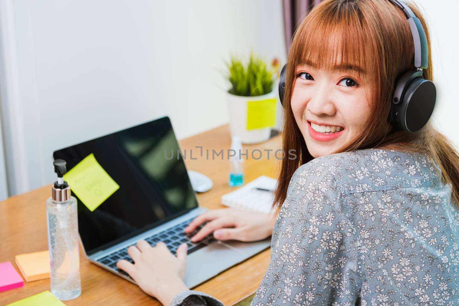 Work from home concept, Happy Asian beautiful young business woman wearing headphone call online conference video call meeting for discussion talking with boos and team together by laptop computer