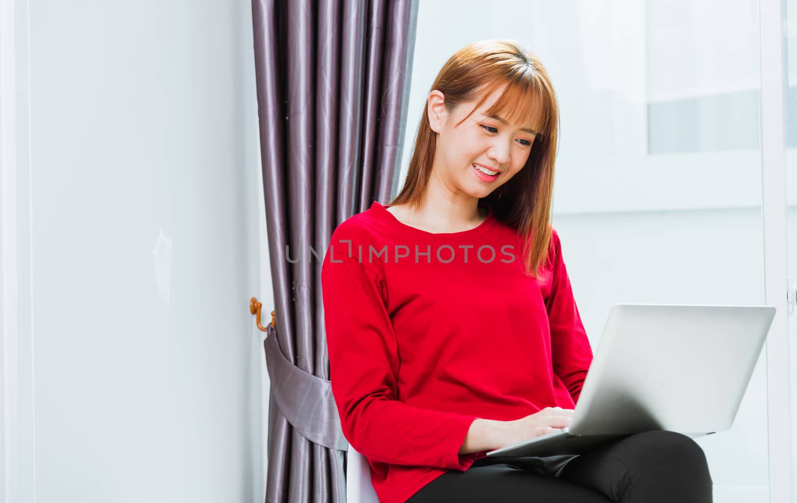Work from home concept, Asian beautiful young woman smiling, student girl sitting on chair during working with laptop computer at home office