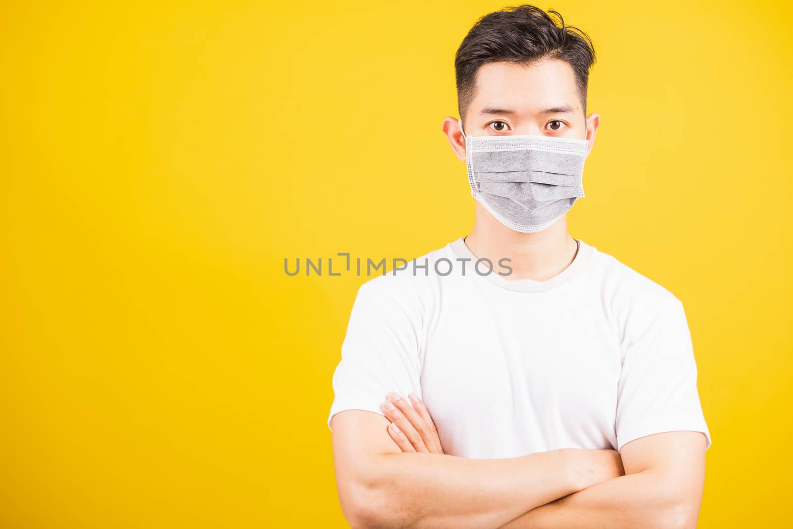 man wearing face mask protective germ virus and stand crossed ar by Sorapop