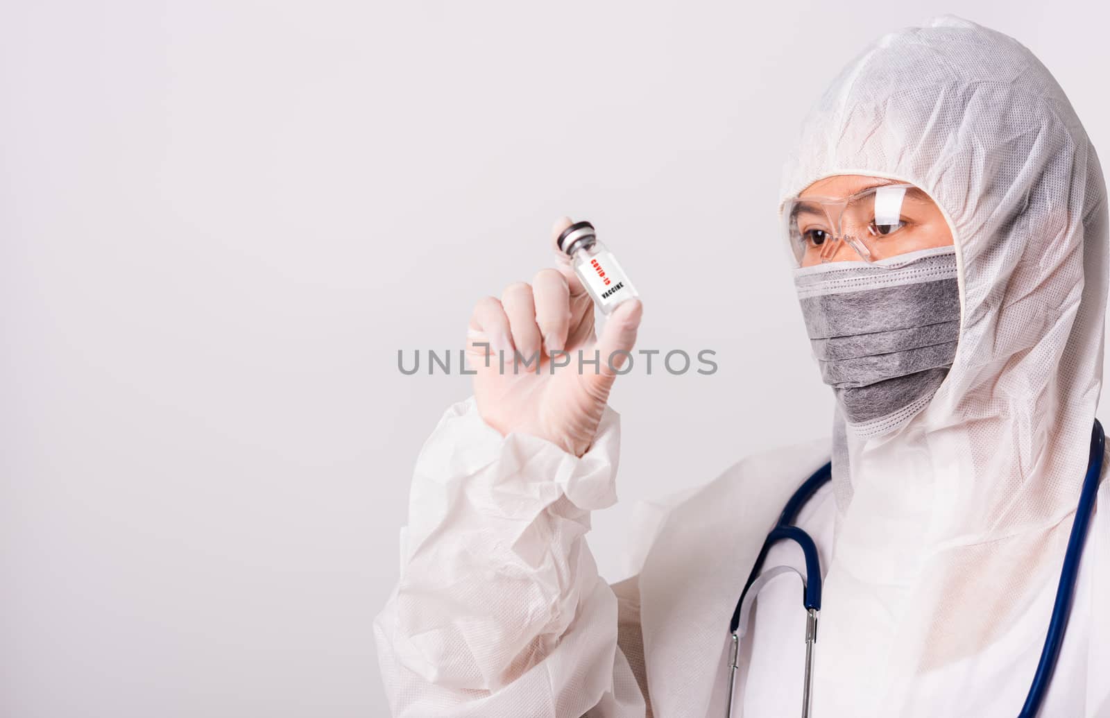 woman doctor in PPE uniform wearing face mask protective in labo by Sorapop