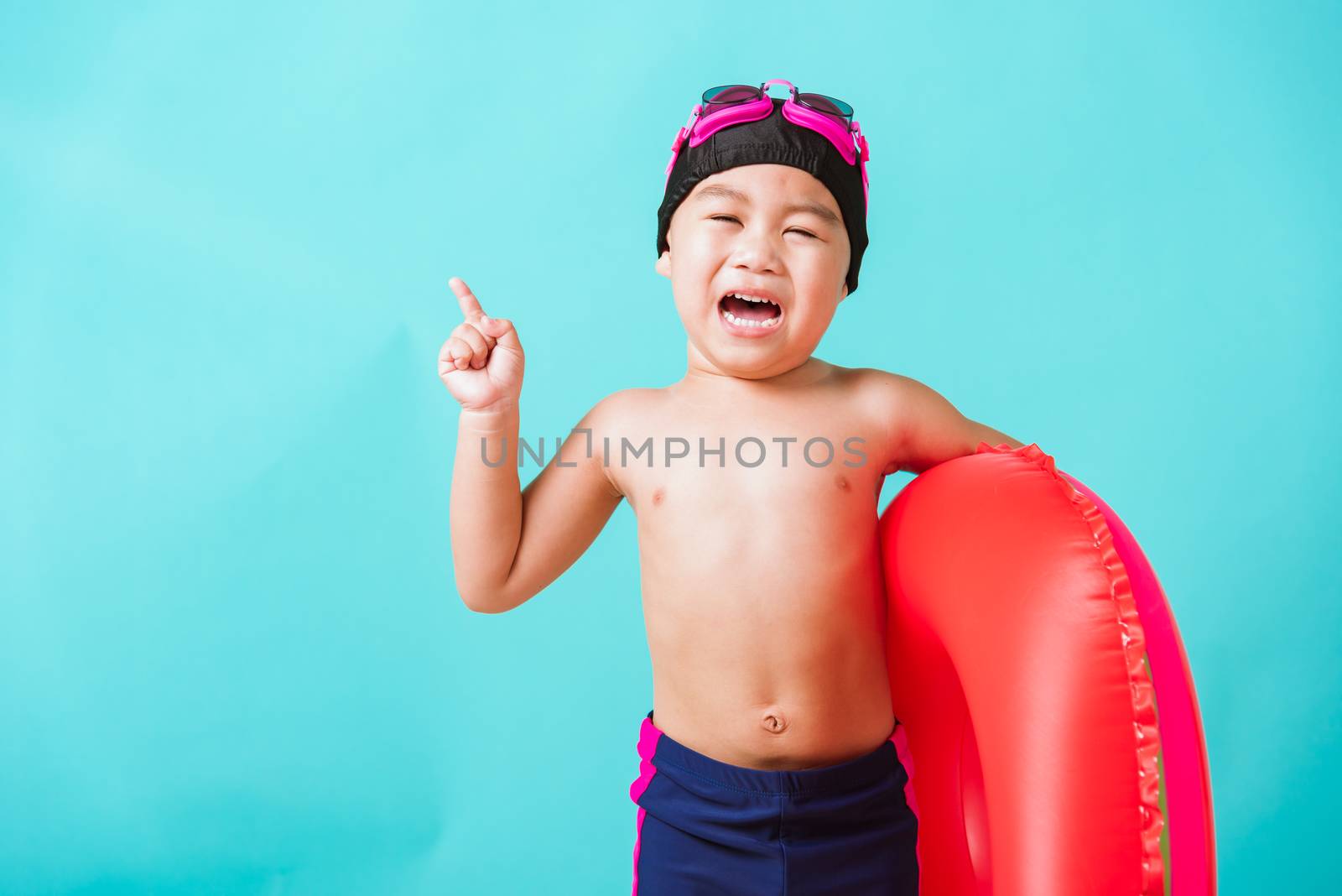 Child boy wearing goggles and swimsuit holding beach watermelon  by Sorapop