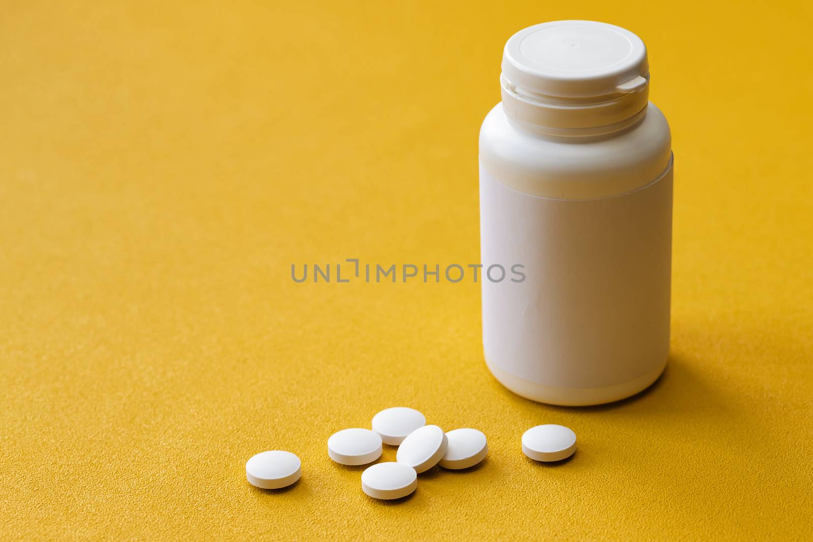 tablet bottle of medicine, photo isolated on a yellow background. Mock-up.