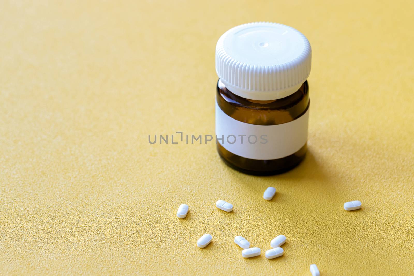 tablet bottle of medicine, photo isolated on a yellow background. Mock-up.