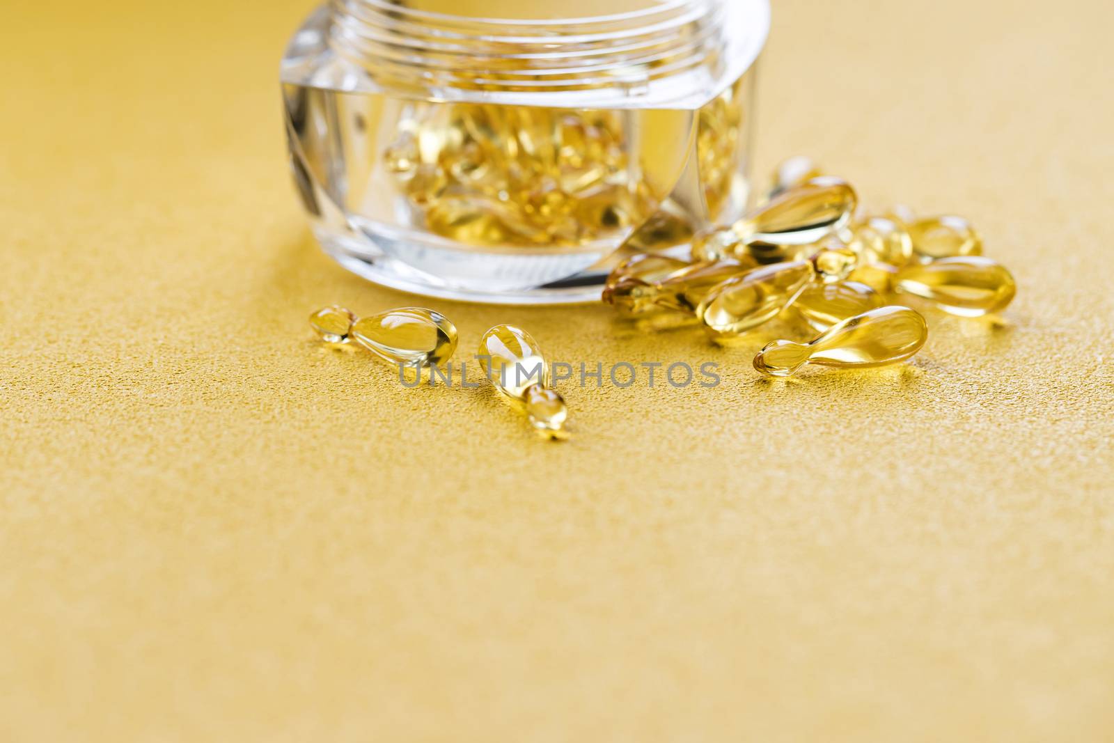 Pharmaceutical medicine tablets, capsules with vitamin D on a bright yellow background. by bonilook